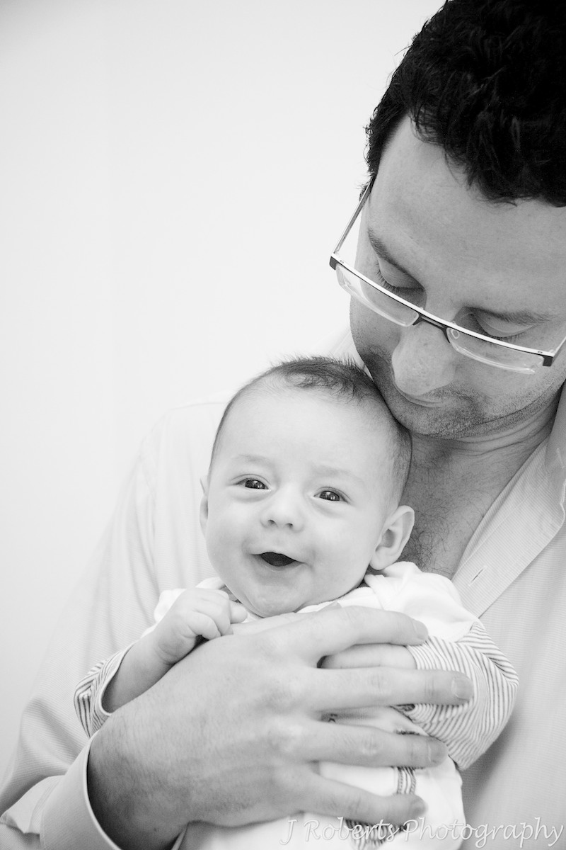 Laughing baby in Daddy's arms - baby portrait photography sydney